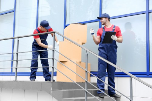 Local furniture collection team removing a sofa from a residential property in Togermany