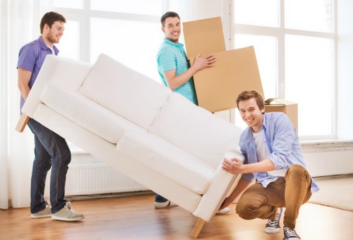 Crew loading wrapped furniture for a cross-border removals job