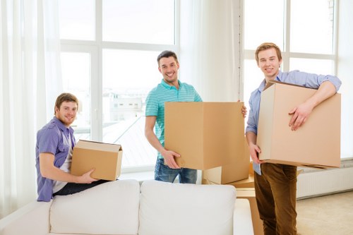 Professional house removalists unloading furniture at a new home