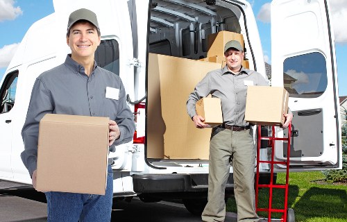 Professional movers handling office furniture and equipment